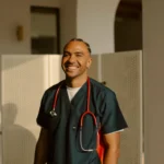 Portrait of a smiling man caregiver in navy scrubs